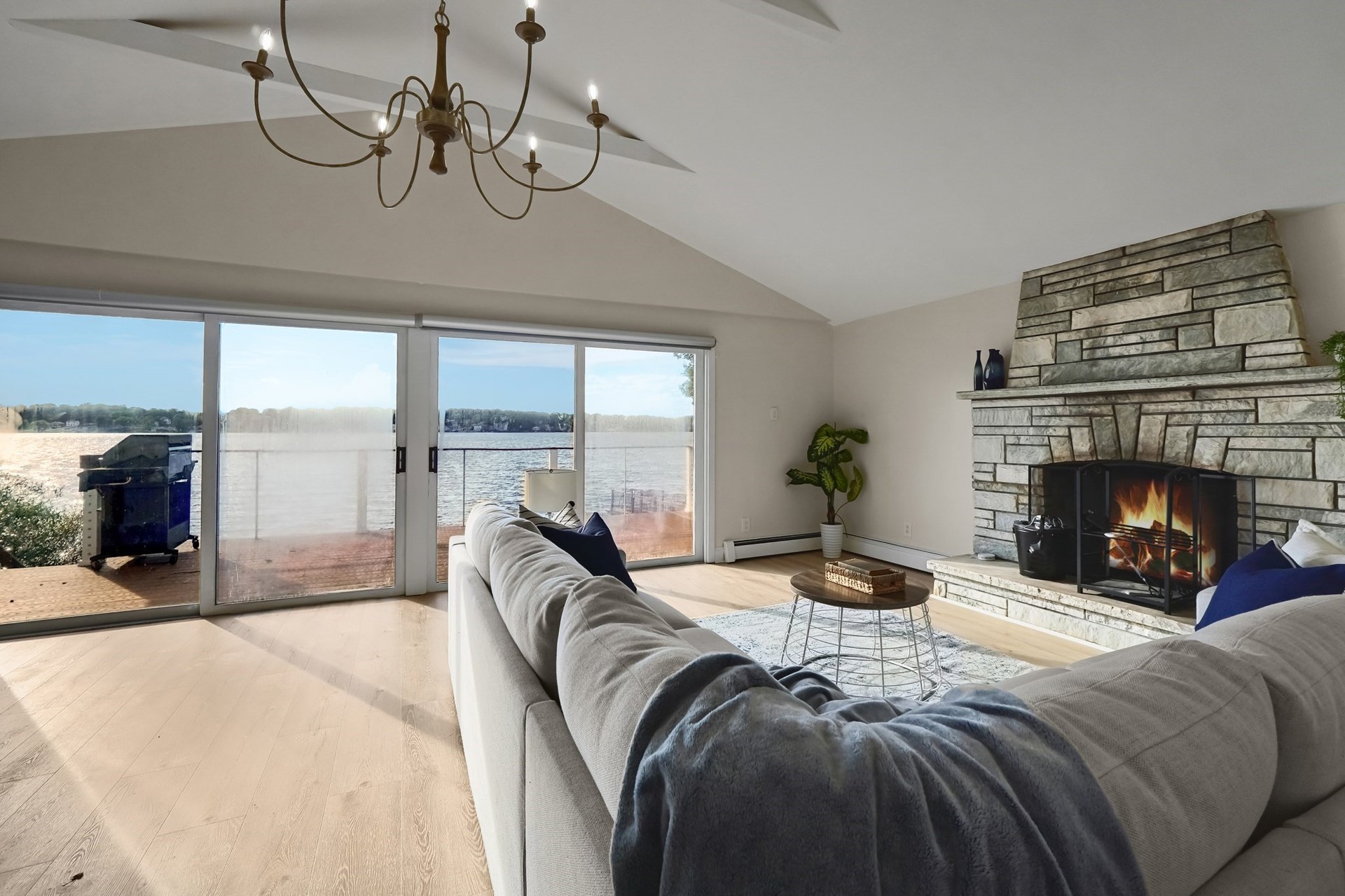 A living room with a stone fireplace